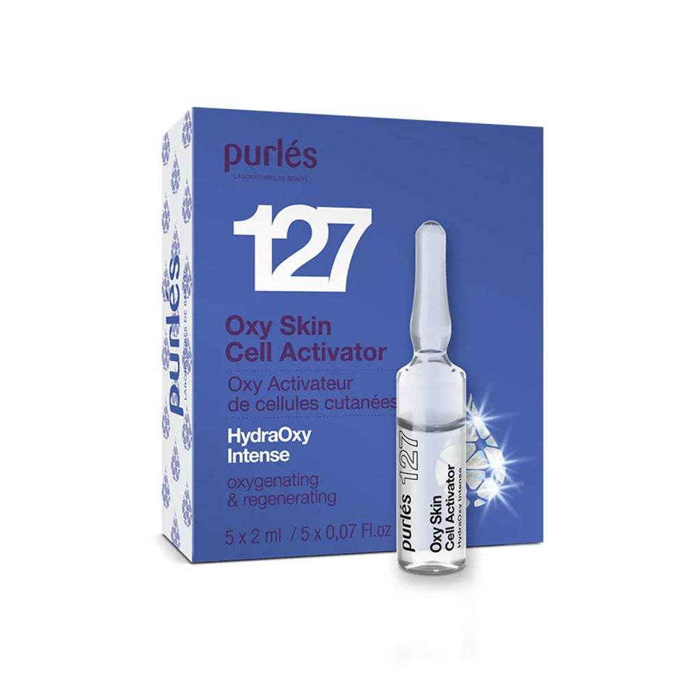 Eine blau-weiße Schachtel mit der Aufschrift Purlés HydraOxy Intense 127 Oxy Skin Cell Activator 5x2ml steht neben einem passenden Fläschchen. Die Verpackung betont die Sauerstoffversorgung und Regeneration der Haut.