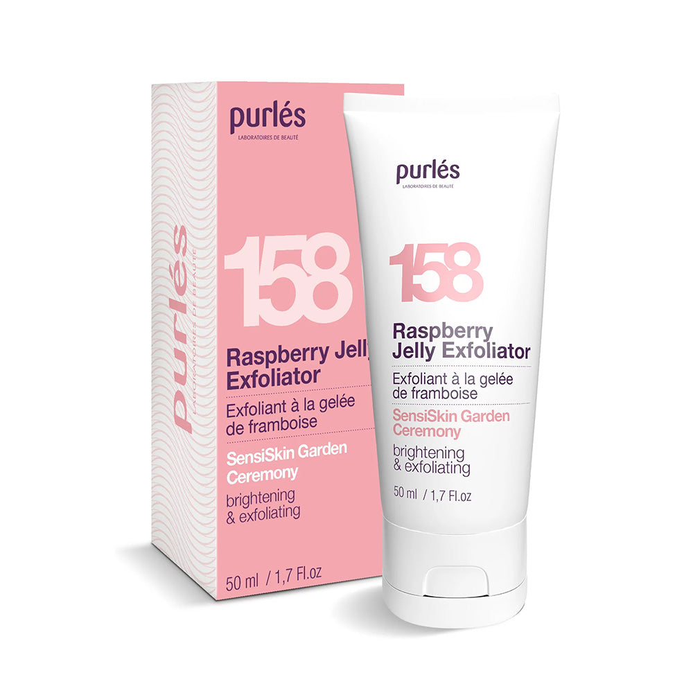 Eine Tube Purlés Sensi Skin Garden Ceremony 158 Raspberry Jelly Exfoliator steht vor der dazugehörigen Schachtel, beide mit dem Etikett für Aufhellung und Peeling versehen und mit einem rosa-weißen Design versehen.
