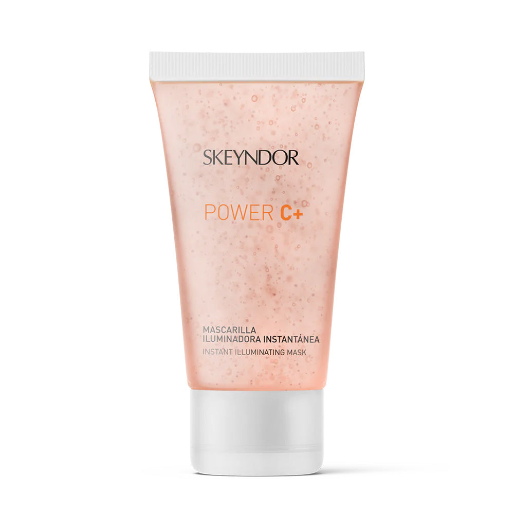 Die Skeyndor POWER C+ INSTANT ILLUMINATING MASK ist aufrecht auf einem weißen Hintergrund abgebildet, wobei das pfirsichfarbene Gel im Inneren der Tube sichtbar ist.