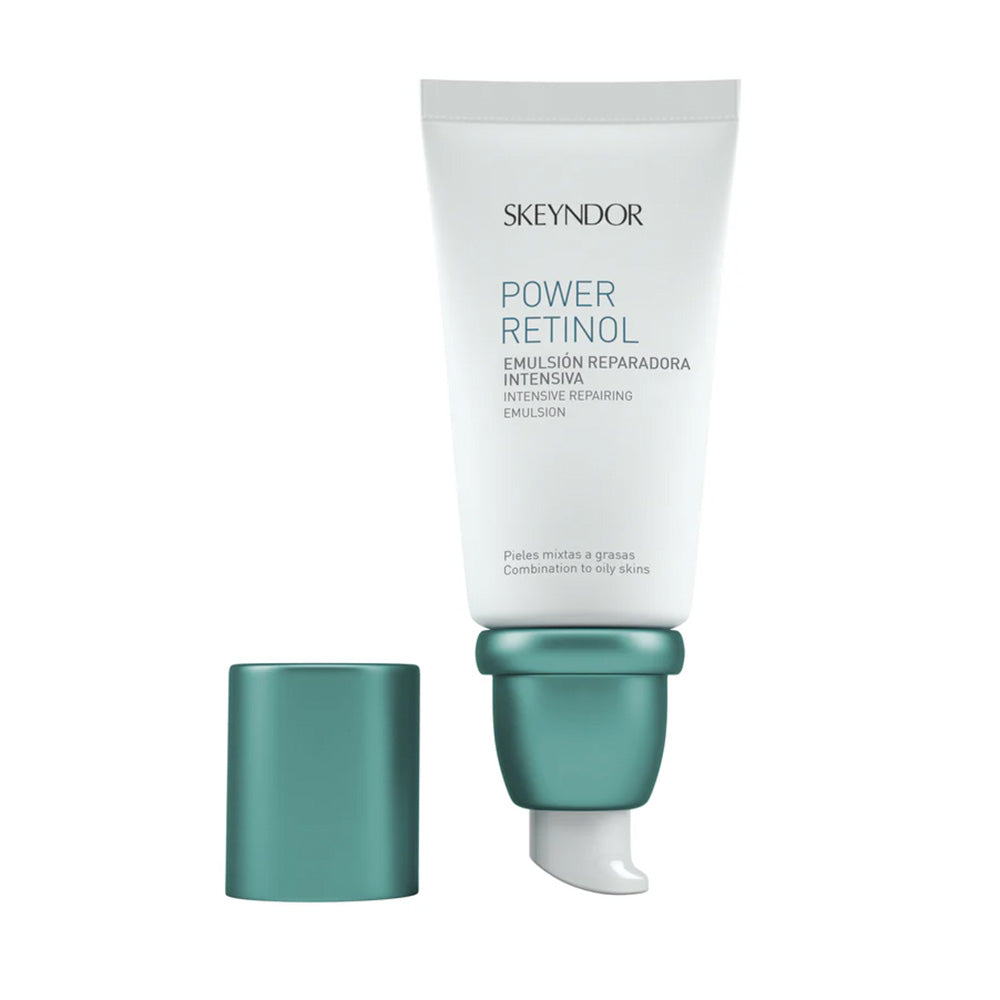 Skeyndor POWER RETINOL INTENSIVE REPAIRING EMULSION in weißer Tube mit tealfarbener Pumpe und Kappe, formuliert für Mischhaut bis fettige Haut.